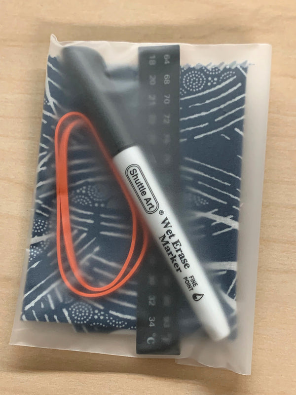 A packaged kombucha accessory kit including a wet erase pen, a rubber band, a stick-on thermometer contained in translucent plastic package. 